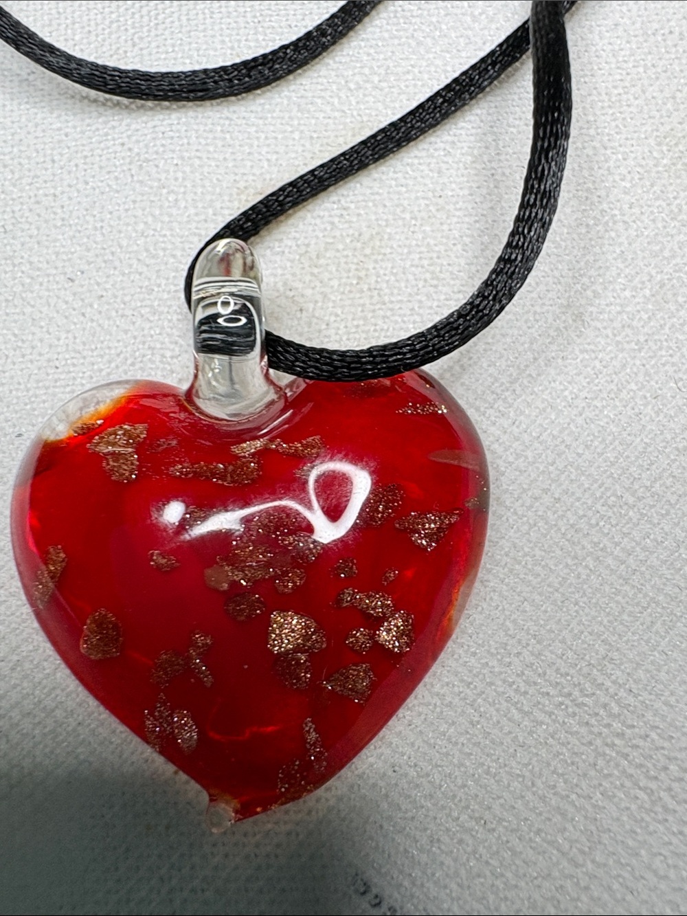 Handblown Red Glass Heart on adjustable black cord. Gold flecks added inside.